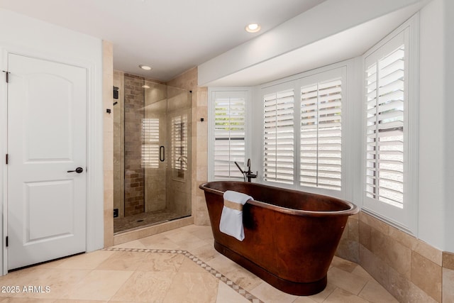 full bathroom with a freestanding bath, tile patterned floors, a stall shower, and recessed lighting