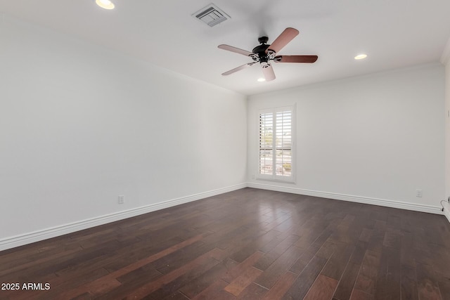 empty room with baseboards, ceiling fan, dark wood-style floors, and visible vents
