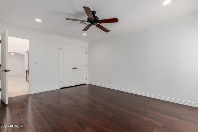 unfurnished bedroom featuring crown molding, dark wood-style flooring, baseboards, and recessed lighting