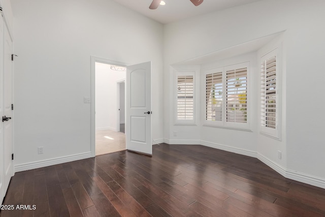 unfurnished bedroom featuring baseboards, ceiling fan, and wood finished floors