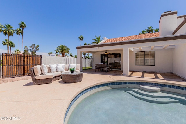 view of pool with ceiling fan, outdoor lounge area, fence, a patio, and a fenced in pool