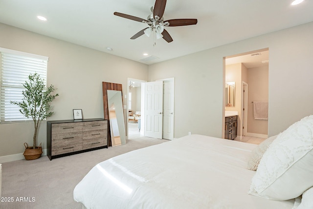 carpeted bedroom with ceiling fan and connected bathroom