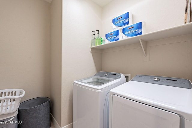 washroom with washing machine and clothes dryer