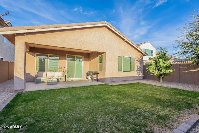 back of house with a patio area and a lawn