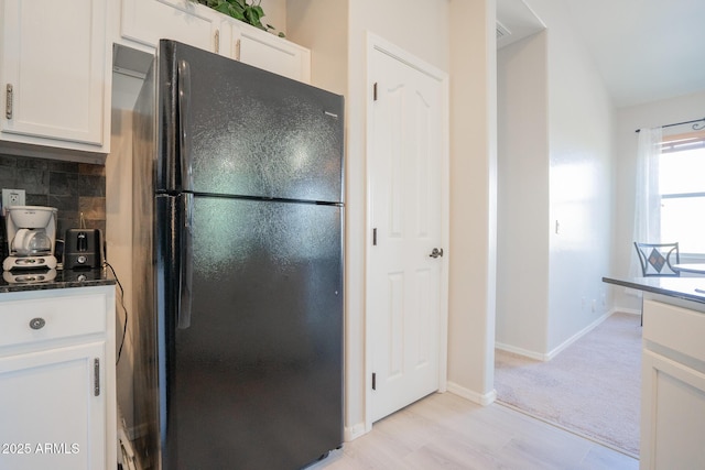 34979 N 30th Ave, Phoenix, AZ 85086 - kitchen featuring freestanding refrigerator, white cabinets, decorative backsplash, dark stone countertops, and baseboards
