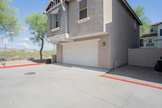 34979 N 30th Ave, Phoenix, AZ 85086 - view of side of home with a garage, stucco siding, and driveway
