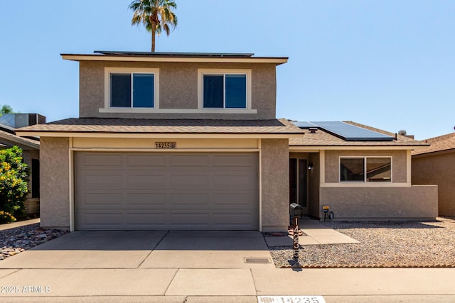 14235 N 26th Ln, Phoenix, AZ 85023 - view of front of house featuring roof mounted solar panels, stucco siding, driveway, and an attached garage