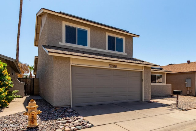 14235 N 26th Ln, Phoenix, AZ 85023 - view of front facade featuring stucco siding, driveway, and a garage