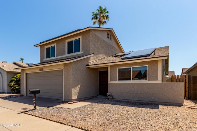 14235 N 26th Ln, Phoenix, AZ 85023 - view of front of house featuring stucco siding, solar panels, a garage, and driveway