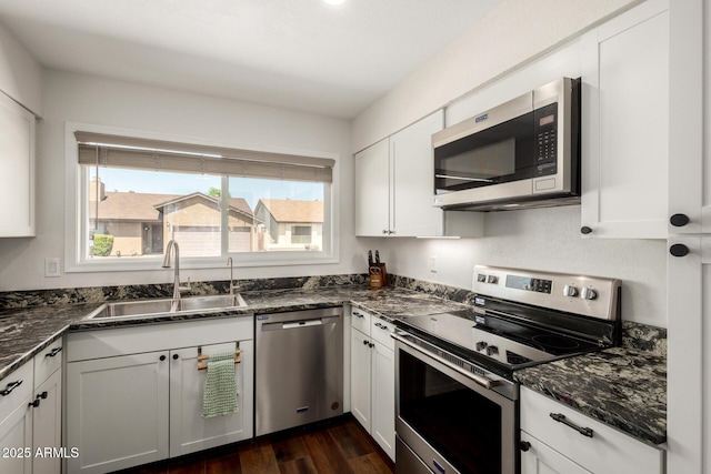 14235 N 26th Ln, Phoenix, AZ 85023 - kitchen with appliances with stainless steel finishes, white cabinets, dark stone counters, and dark wood-type flooring