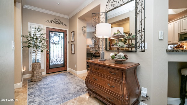 foyer with ornamental molding and light tile patterned floors