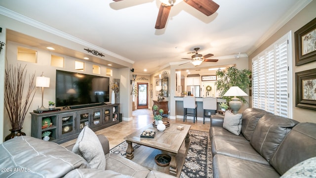 living room with ceiling fan and ornamental molding