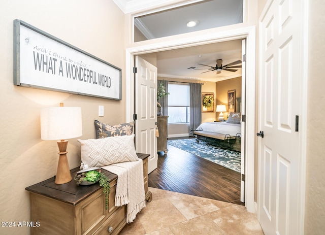 bedroom with ornamental molding, hardwood / wood-style flooring, and ceiling fan