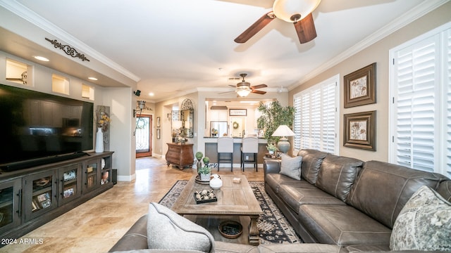 living room featuring ornamental molding and ceiling fan