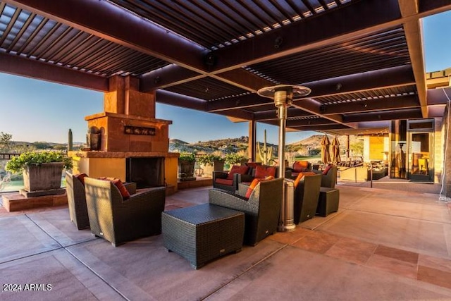 view of patio / terrace with an outdoor living space with a fireplace, a mountain view, and a pergola