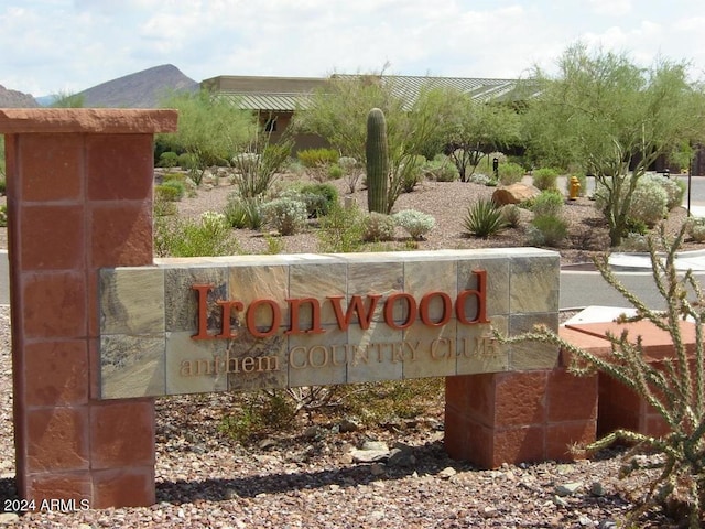 community / neighborhood sign with a mountain view