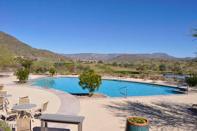 view of pool featuring a mountain view and a patio area