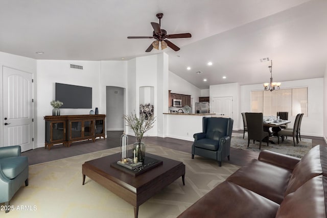 living room featuring ceiling fan with notable chandelier and high vaulted ceiling