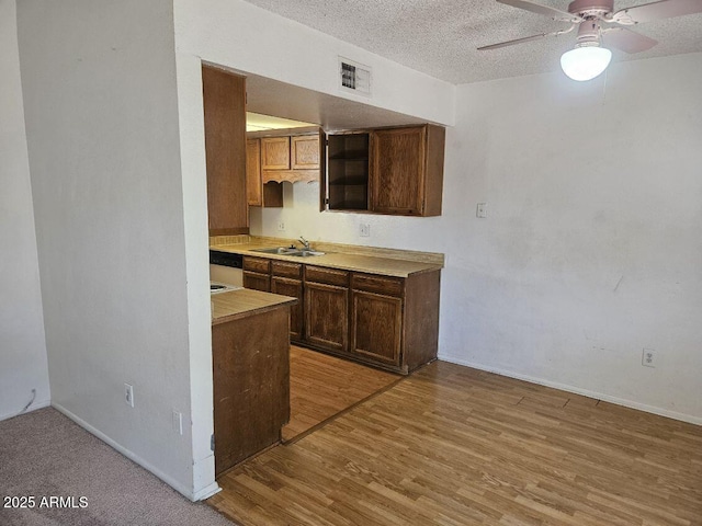 3807 W Mitchell Dr, Phoenix, AZ 85019 - kitchen with a sink, light wood finished floors, light countertops, baseboards, and ceiling fan
