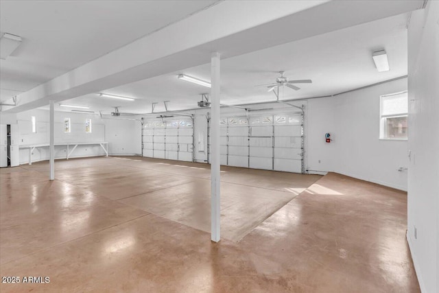 garage with a garage door opener and ceiling fan