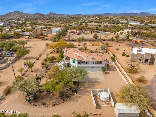 birds eye view of property with a mountain view