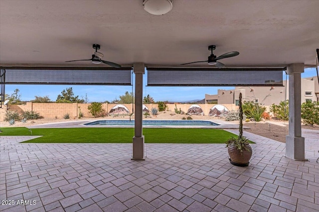 view of patio / terrace with a fenced backyard, ceiling fan, and a fenced in pool