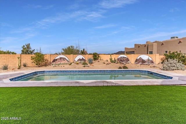 view of swimming pool featuring a fenced backyard and a yard