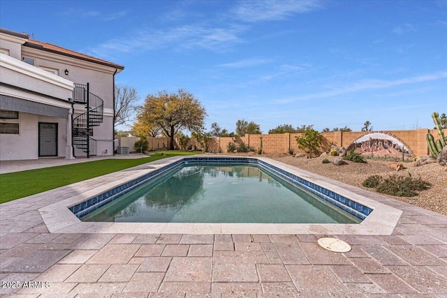 view of pool with a patio area, a fenced backyard, stairway, and a fenced in pool