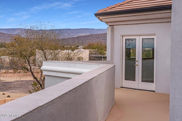 balcony featuring french doors and a mountain view