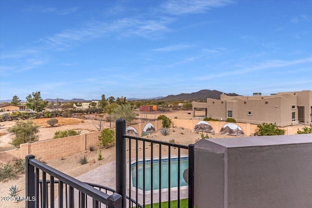 view of yard with a fenced backyard, a mountain view, and a fenced in pool