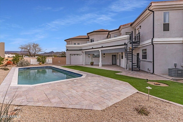 rear view of house featuring a fenced in pool, stairway, fence, a patio area, and stucco siding