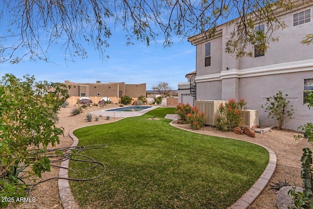 view of yard with central AC unit, a residential view, fence, and a fenced in pool