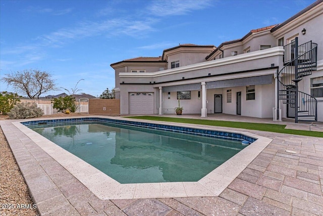 view of pool with fence, stairway, a fenced in pool, and a patio