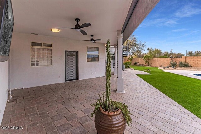 view of patio with a fenced backyard, visible vents, and ceiling fan