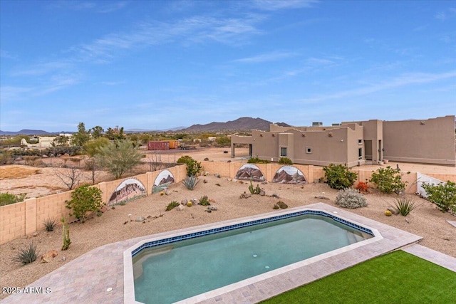 view of pool featuring a fenced in pool, a fenced backyard, and a mountain view