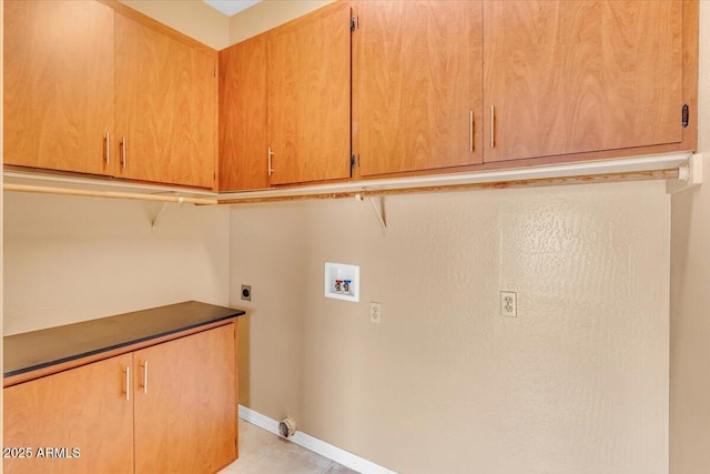 clothes washing area featuring hookup for a washing machine, cabinet space, electric dryer hookup, and baseboards