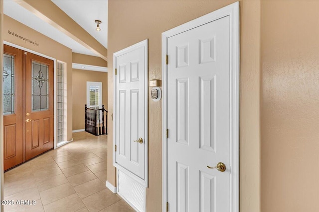 foyer with light tile patterned floors and baseboards