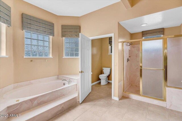 bathroom featuring a garden tub, toilet, baseboards, a shower stall, and tile patterned floors