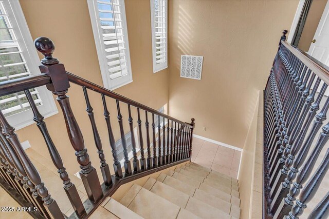 staircase with tile patterned flooring and baseboards