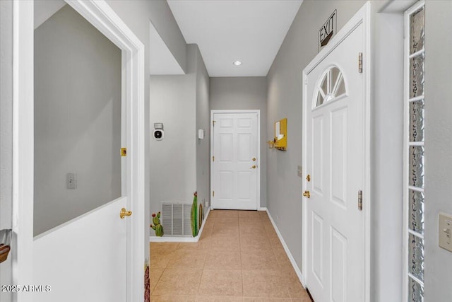 corridor with recessed lighting, visible vents, baseboards, and light tile patterned floors