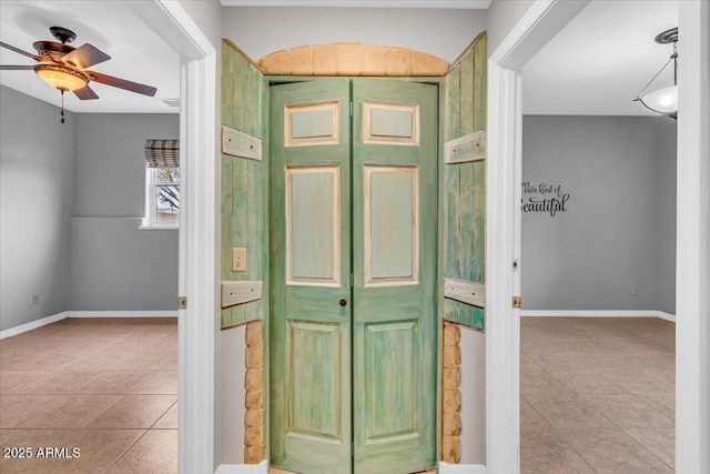 doorway to property featuring a ceiling fan