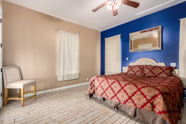 bedroom with light wood-type flooring and ceiling fan