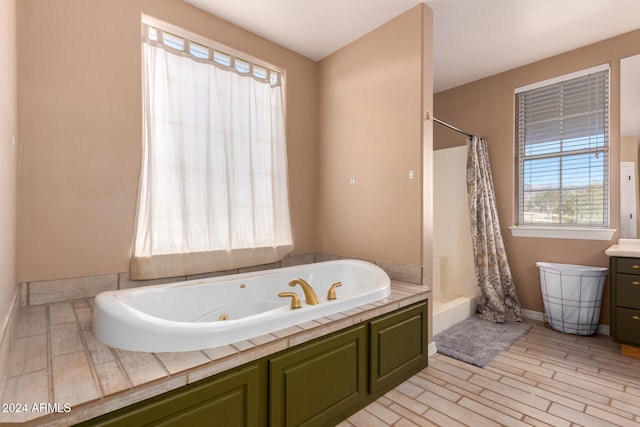 bathroom with separate shower and tub and vanity