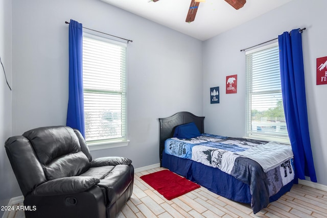 bedroom with multiple windows and ceiling fan