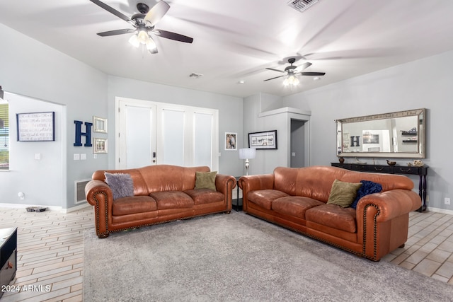 carpeted living room with ceiling fan