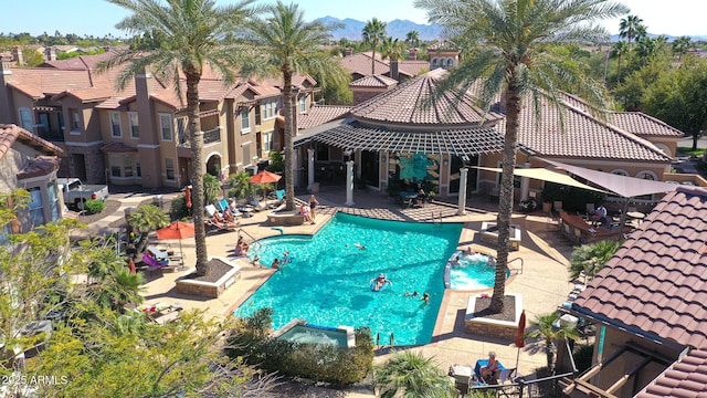 pool featuring a patio area and a residential view