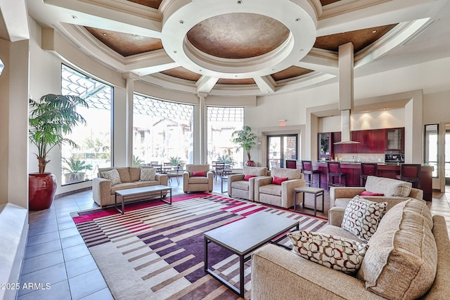 living room with light tile patterned flooring, coffered ceiling, a towering ceiling, and ornamental molding