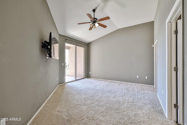 empty room featuring baseboards, lofted ceiling, carpet, and ceiling fan