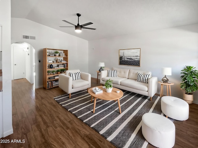living area featuring visible vents, a ceiling fan, wood finished floors, arched walkways, and vaulted ceiling