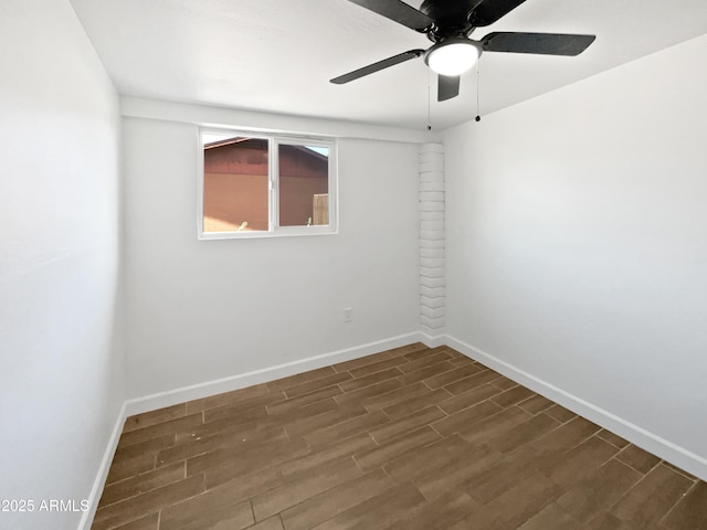 empty room with baseboards, ceiling fan, and dark wood-type flooring